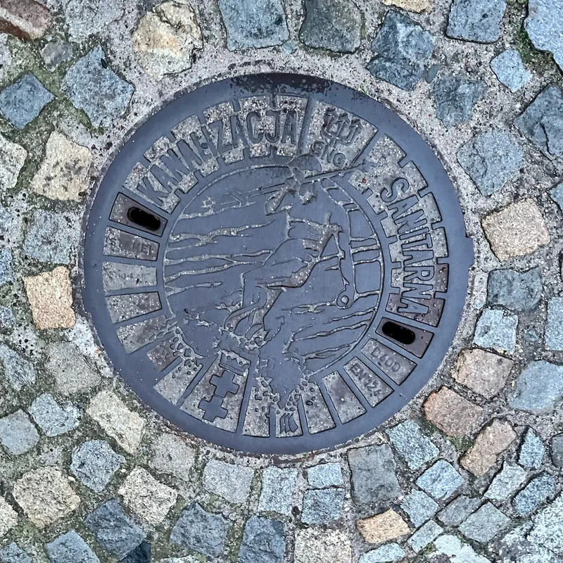 Manhole cover in Środmieście, Poland