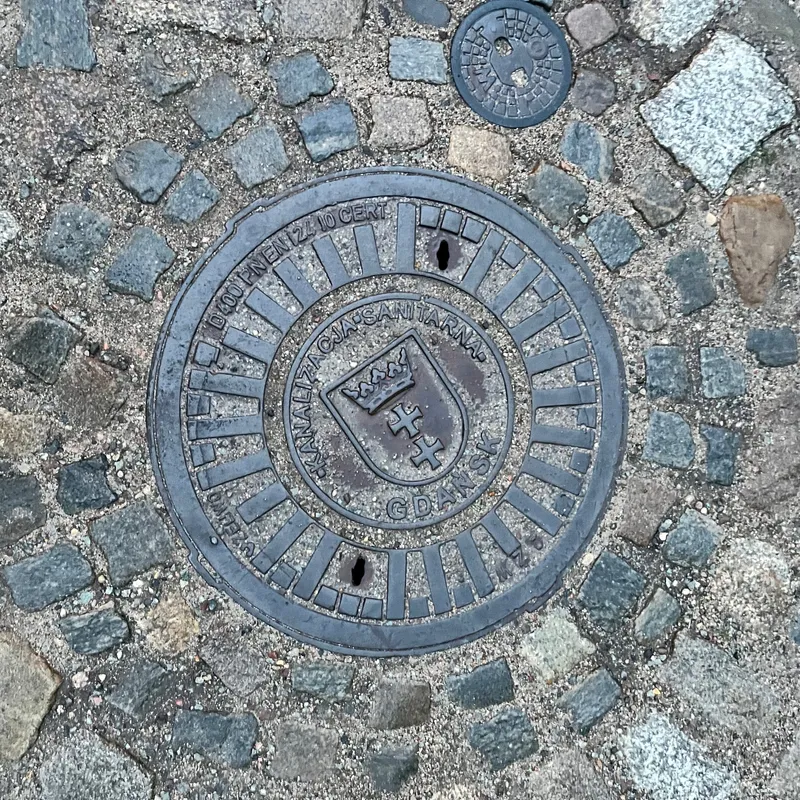 Manhole cover in Środmieście, Poland